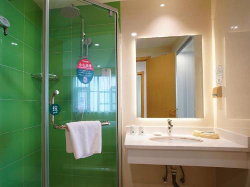 y baño con lavabo y ducha con espejo. en GreenTree Inn Xingtai Renze District People Street Business Hotel en Ren
