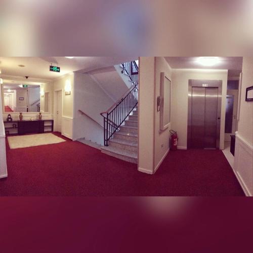 a hallway of a building with a staircase and a stair case at Theranda Hotel in Prizren
