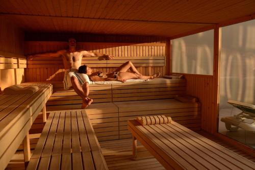 a man and two people in a sauna at Les Terrasses d'Atlanthal in Anglet