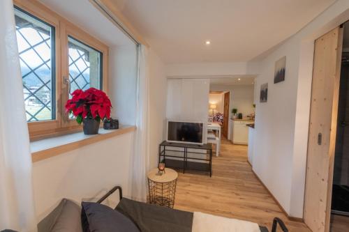 a living room with a couch and a television at Florin Ferien in Klosters
