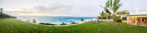 a house with a view of the ocean at Coral Sea private beachfront panorama with infinity pool in Tuckerʼs Town