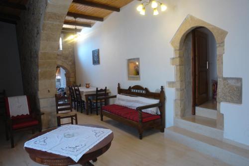 a room with a bed and a table and chairs at Villa Eleva in Aryiroúpolis