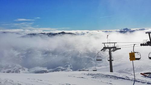 a ski lift on top of a snow covered mountain at Landhaus Lilly in Obertraun