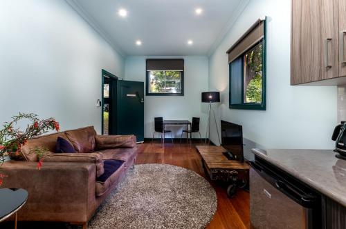 a living room with a couch and a table at Tuck Inn Yarra Valley in Healesville