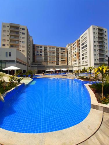 a large blue swimming pool in front of some buildings at PARK VEREDAS FLAT 322 in Rio Quente