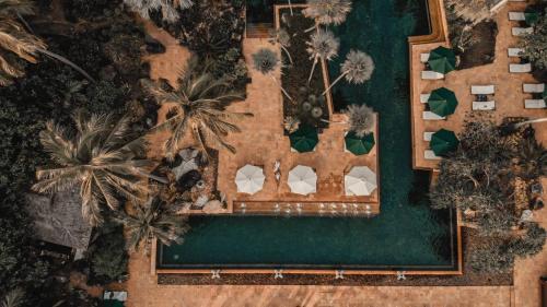 an overhead view of a swimming pool with palm trees at JW Marriott Phuket Resort and Spa in Mai Khao Beach