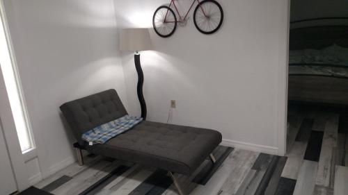 a chair in a room with a bike on the wall at Tampa Lakehouse in Tampa