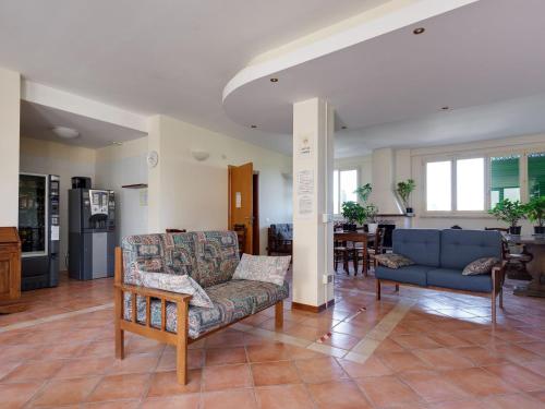 a living room with two couches and a kitchen at Comfortable Mansion in Siena with Swimming Pool in Siena