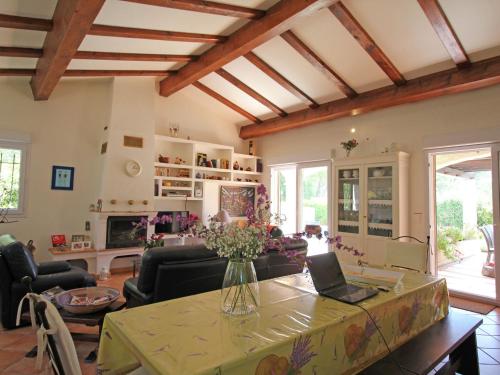 a living room with a table with a vase of flowers on it at Gorgeous Villa in Bagnols en For t in Bagnols-en-Forêt