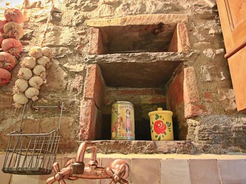 a brick oven with two vases and a sink at Holiday Home in Apecchio with Pool & Terrace in Apecchio