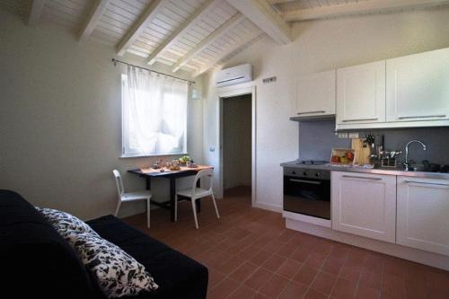 a kitchen with a couch and a table in a room at Casali Romei in Sarzana