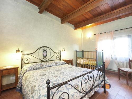 a bedroom with a bed and a window at Farmhouse in Apecchio with Swimming Pool Terrace Garden BBQ in Apecchio