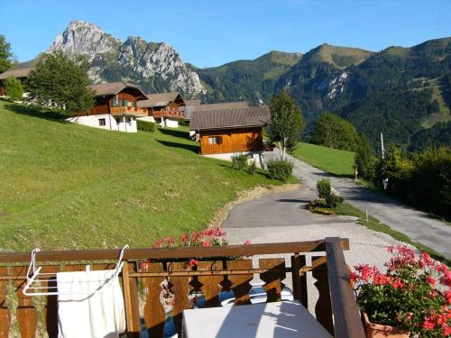 a view of a house on a hill with mountains at Chalet Titlis in Bernex