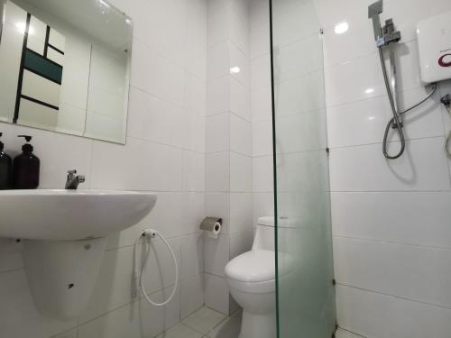 a white bathroom with a toilet and a sink at Thermospace The Wave B-13A-13 Melaka City in Melaka