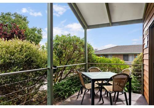 a patio with a table and chairs on a balcony at Discovery Parks - Warrnambool in Warrnambool
