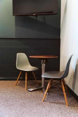 a table and two chairs sitting next to a table at Tuck Inn Yarra Valley in Healesville