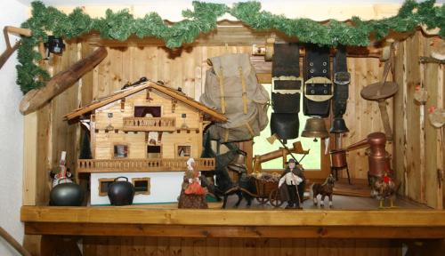 a wooden shelf with a model of a house at Chalet Titlis in Bernex