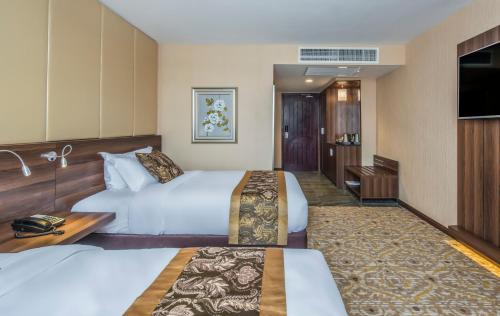 Postel nebo postele na pokoji v ubytování Marcian Garden Hotel