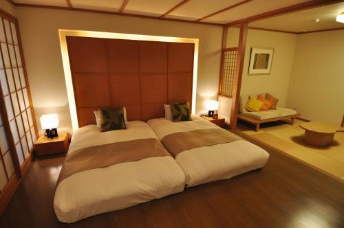 a bedroom with a large bed in a room at Dogo Prince Hotel in Matsuyama