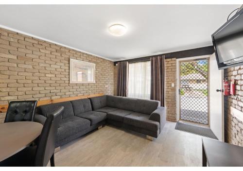 a living room with a couch and a table at Discovery Parks - Warrnambool in Warrnambool