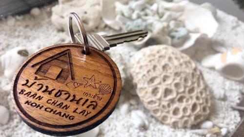 a key chain on top of a pile of shells at Baan Chan Lay Koh Chang in Ko Chang
