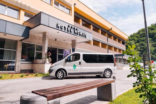 a white van parked in front of a building at Garden City Hotel Konjic in Konjic