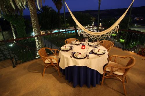a table with plates of food on a balcony at night at Solar de Chacim - Turismo de Habitação in Chacim