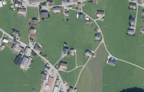 an aerial view of a bunch of houses in a field at Ferienwohnung Berchtold in Schnepfau