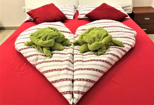 two stuffed animals are laying on a bed at Valpolicella Hills in Negrar