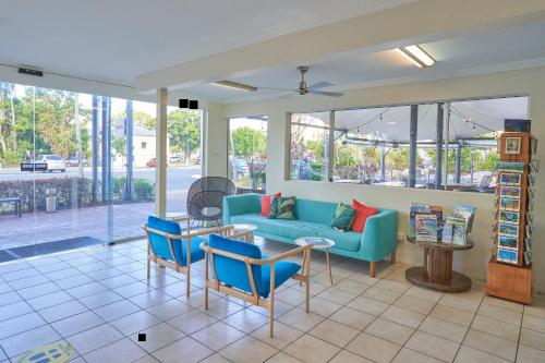 a living room filled with lots of furniture at Cairns Queenslander Hotel & Apartments in Cairns