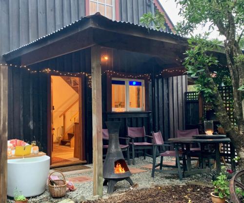 a small house with a fireplace in a yard at Quail Farm, Colonial charm in Nelson