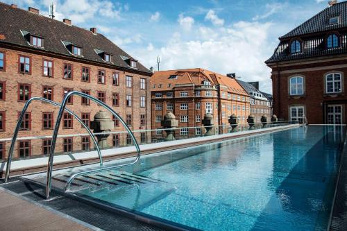 a large swimming pool in front of a building at Villa Copenhagen in Copenhagen