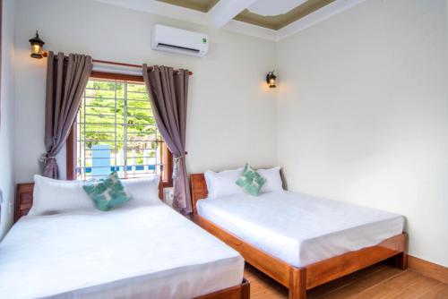 Ένα ή περισσότερα κρεβάτια σε δωμάτιο στο Cong Man Homestay Cham Island