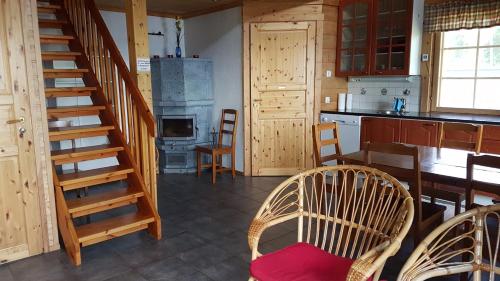 a kitchen with a staircase and a table and chairs at Kauppilan Rantasauna in Ikaalinen