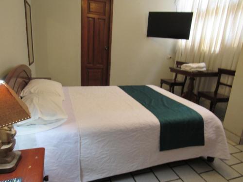 A bed or beds in a room at Las Orquídeas Hotel 3 estrellas