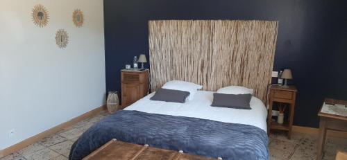 a bedroom with a bed with two pillows on it at Chambres d'Hôtes La Luzernière in Saint-Denis-de-Pile