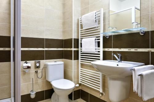 a bathroom with a toilet and a sink at Hotel Rozálka in Pezinok