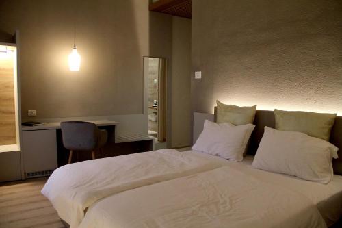 a bedroom with a large bed with white sheets and pillows at Albergo Ristorante Palladio Osteria dal 1900 in Fratta Polesine