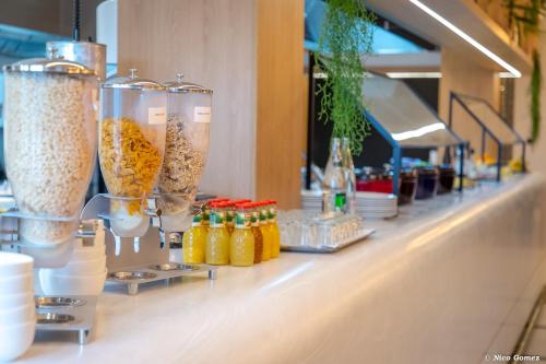 a row of vases on a counter in a restaurant at Mercure Chantilly Resort & Conventions in Chantilly