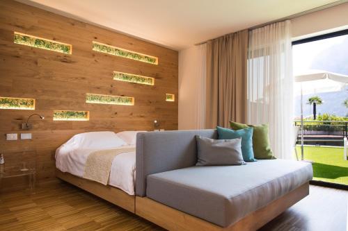 um quarto com uma cama grande e uma janela em Astoria Resort em Riva del Garda