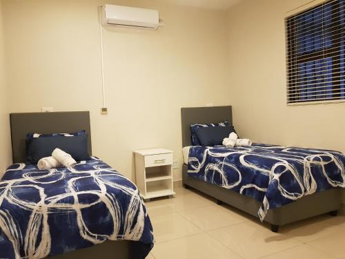 two beds sitting next to each other in a bedroom at Westbrook Cabanas 1st in Westbrook