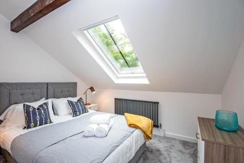 a bedroom with a large bed with a skylight at 52 Old Elvet in Durham
