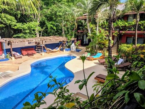 a resort with a swimming pool and trees at Massai Apartments in Playa Flamingo