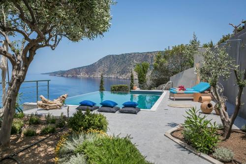 a swimming pool with a view of the water at Braunis Horio Villas in Asos