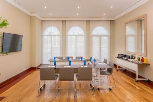 a conference room with a long table and chairs at Palacio de Sancti Petri, a Gran Meliá - The Leading Hotels of the World in Chiclana de la Frontera
