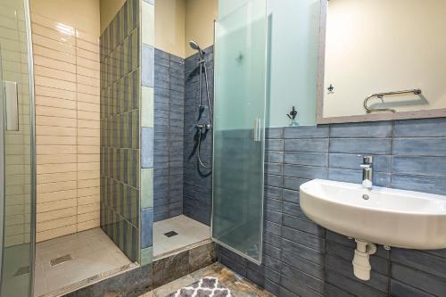 a bathroom with a sink and a glass shower at Blue Bird Hostel in Riga Old Town in Rīga