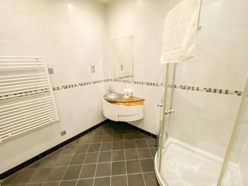 a bathroom with a sink and a shower at St Giles House in Norwich