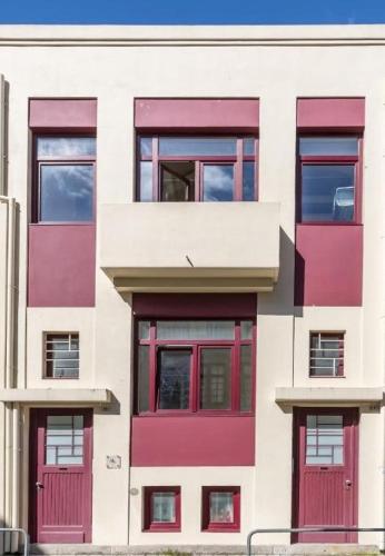 a white building with red doors and windows at PATH Bonjardim Apartments in Porto