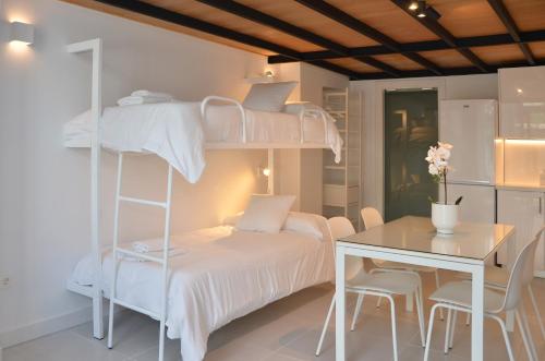a bedroom with a bunk bed and a table and a desk at Canary Lofts in Santa Cruz de Tenerife