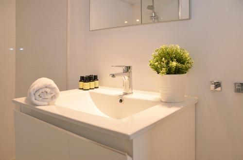 a white sink in a bathroom with a mirror at Canary Lofts in Santa Cruz de Tenerife